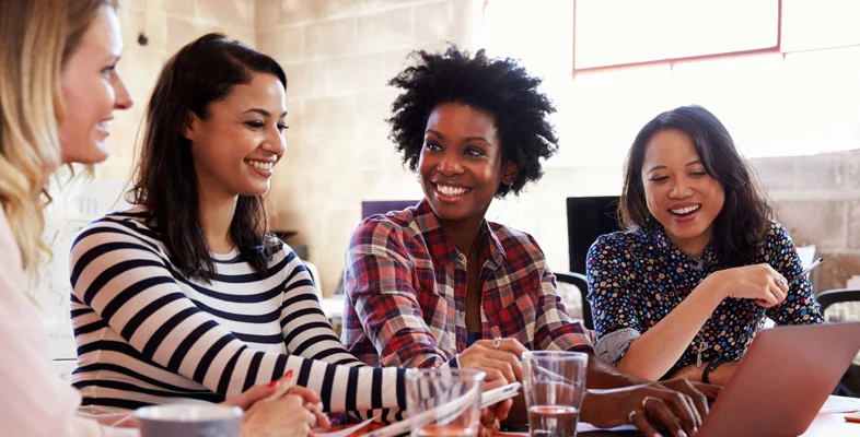 Tech women collaborating on laptops at International Women Hackathon 2019 event