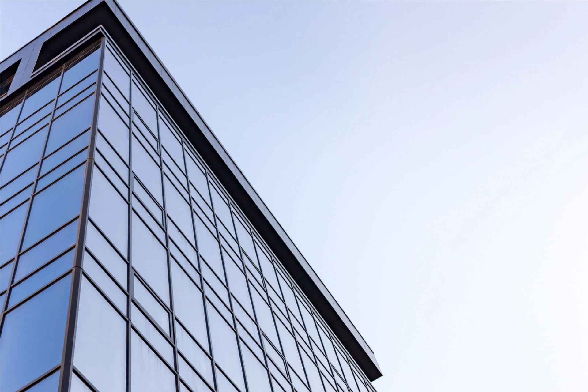 Exterior view of a modern glass building showcasing architectural design.