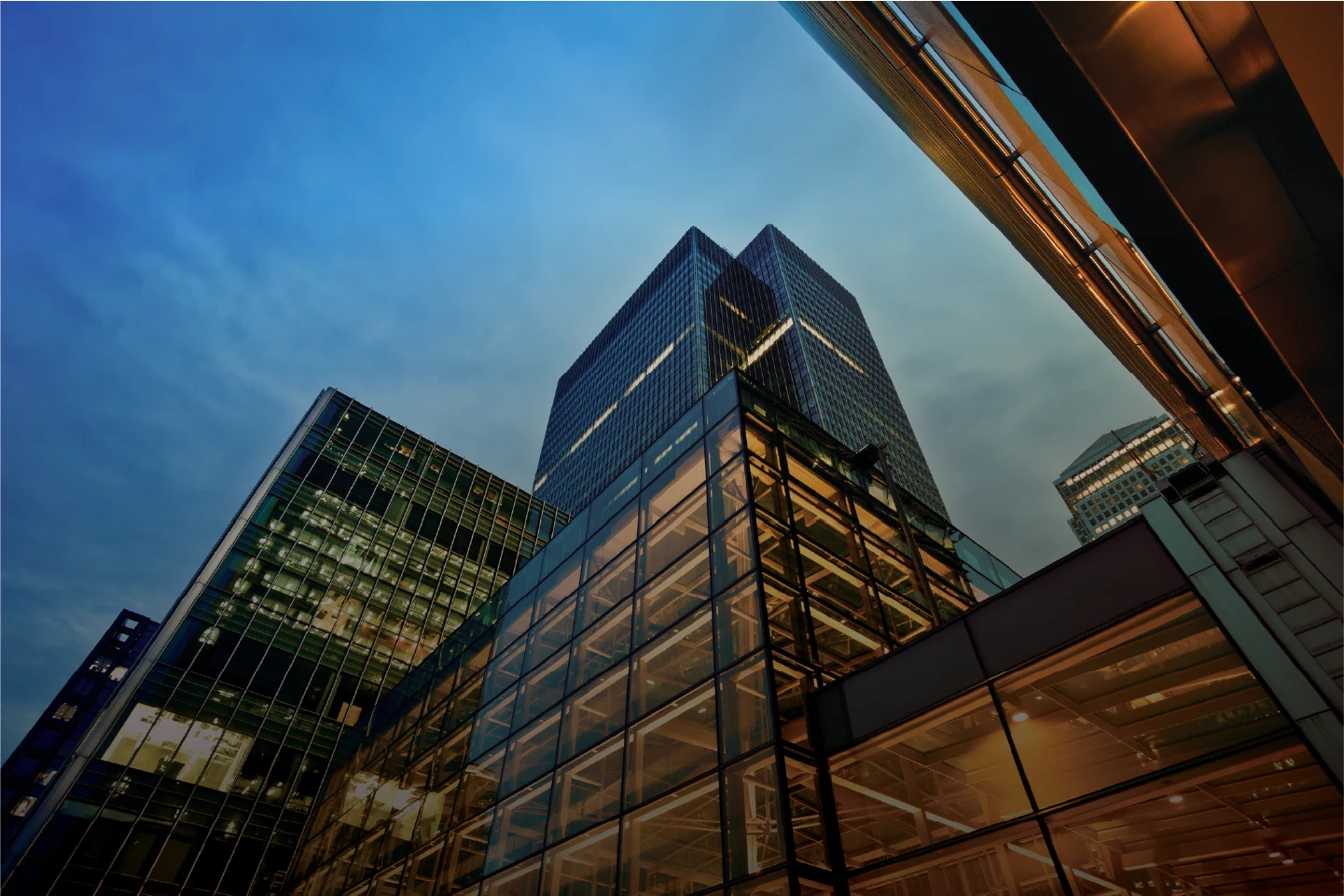 Low-angle view of modern buildings under a blue sky
