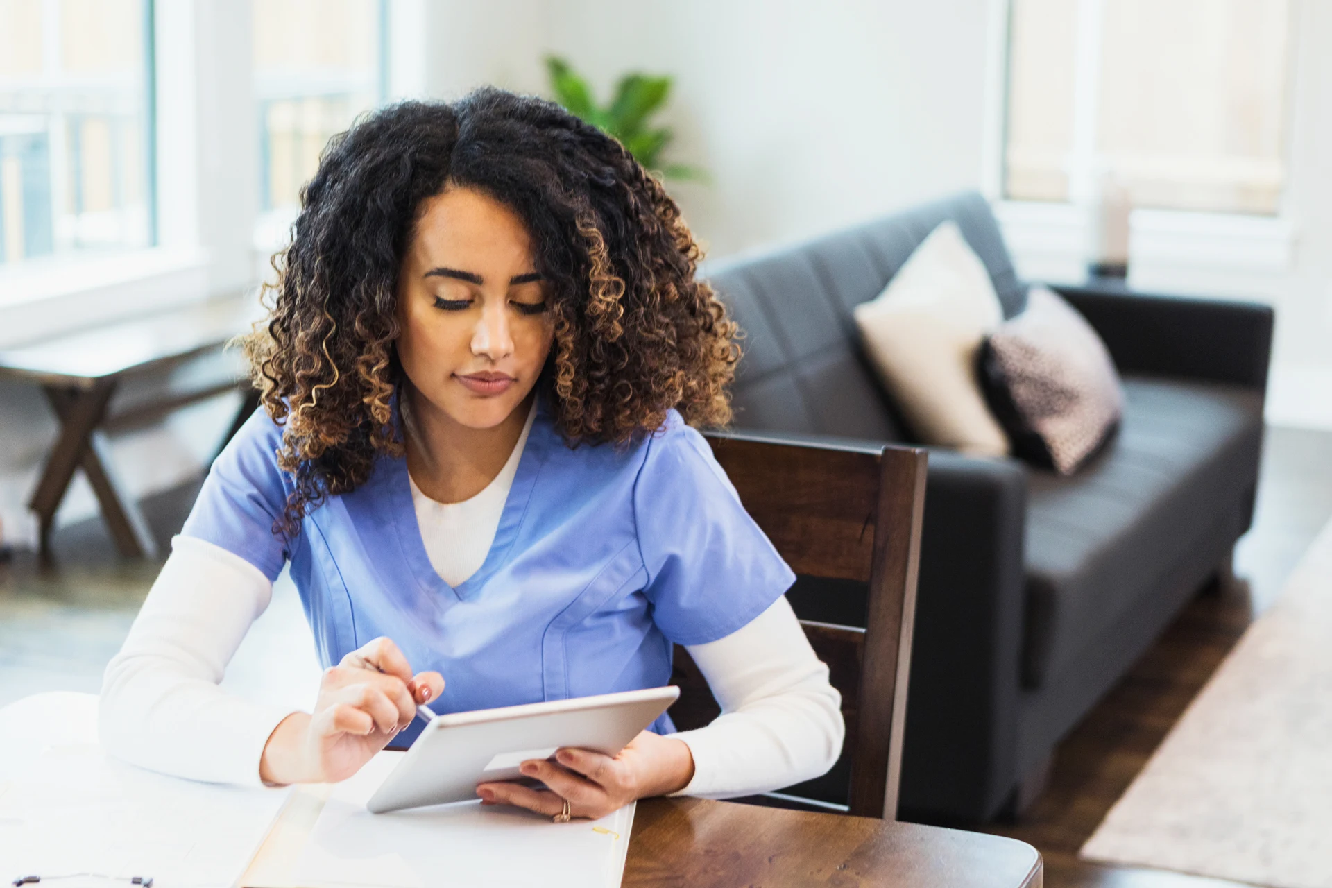 Healthcare professional using a tablet at a workspace for e-commerce solutions