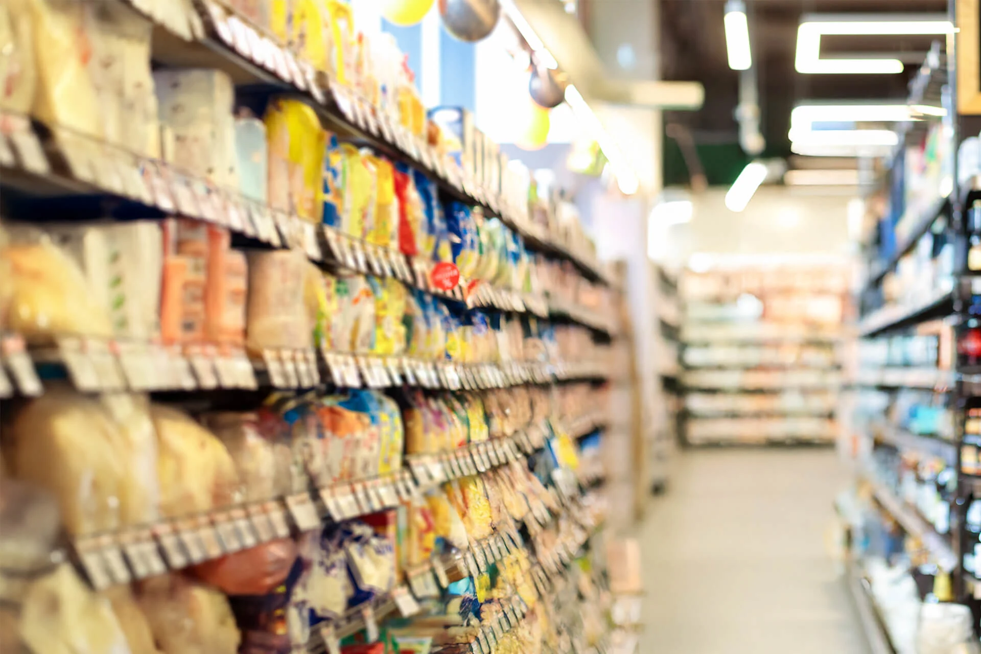 Shelves stocked with various food products in a retail store aisle