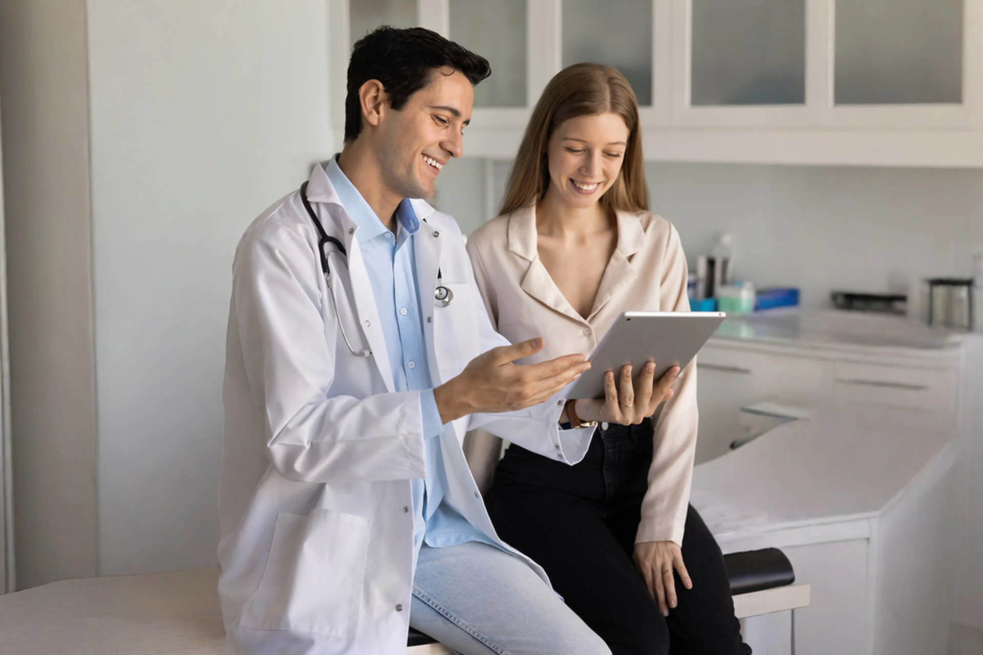 Doctor discussing information on a tablet with a patient in a clinic