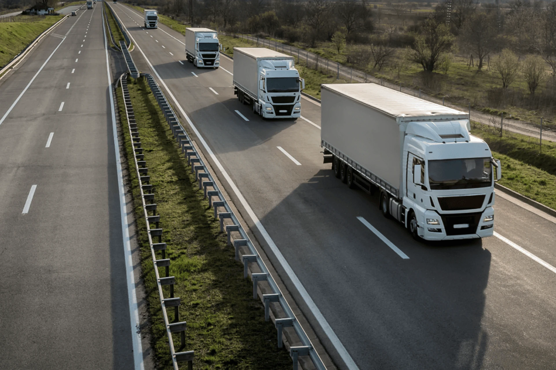 Trucks driving on a highway, illustrating transport for toll services.