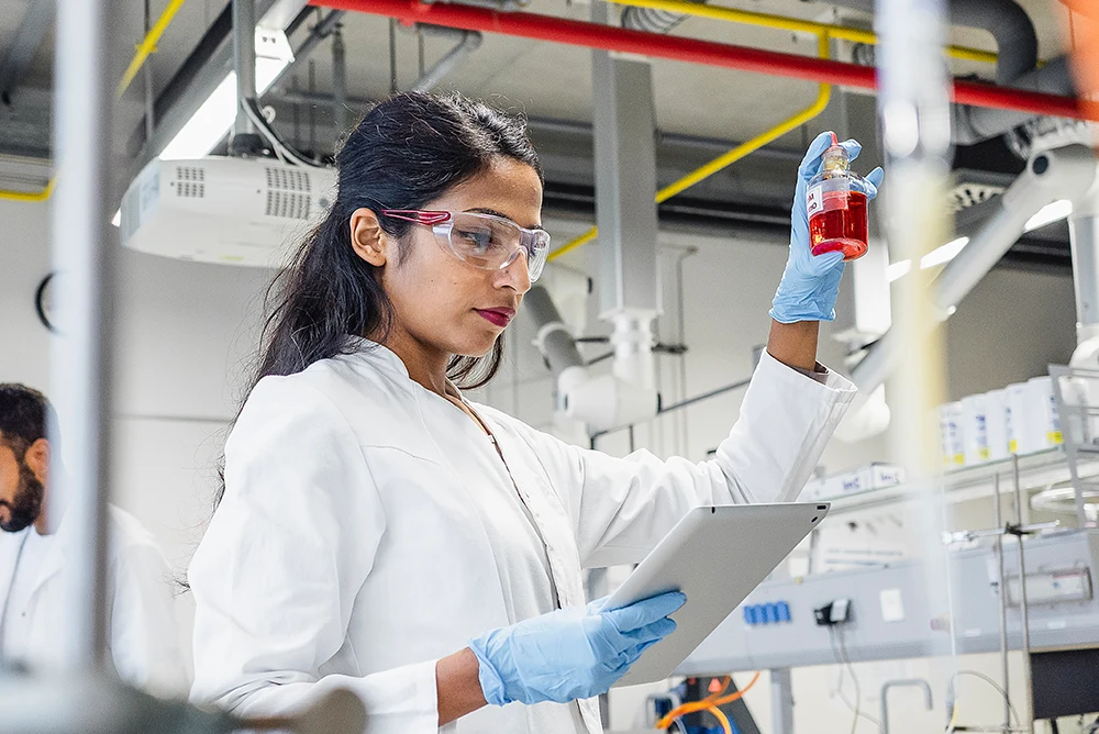 Researchers using digital measurement tools for chemical and industrial testing