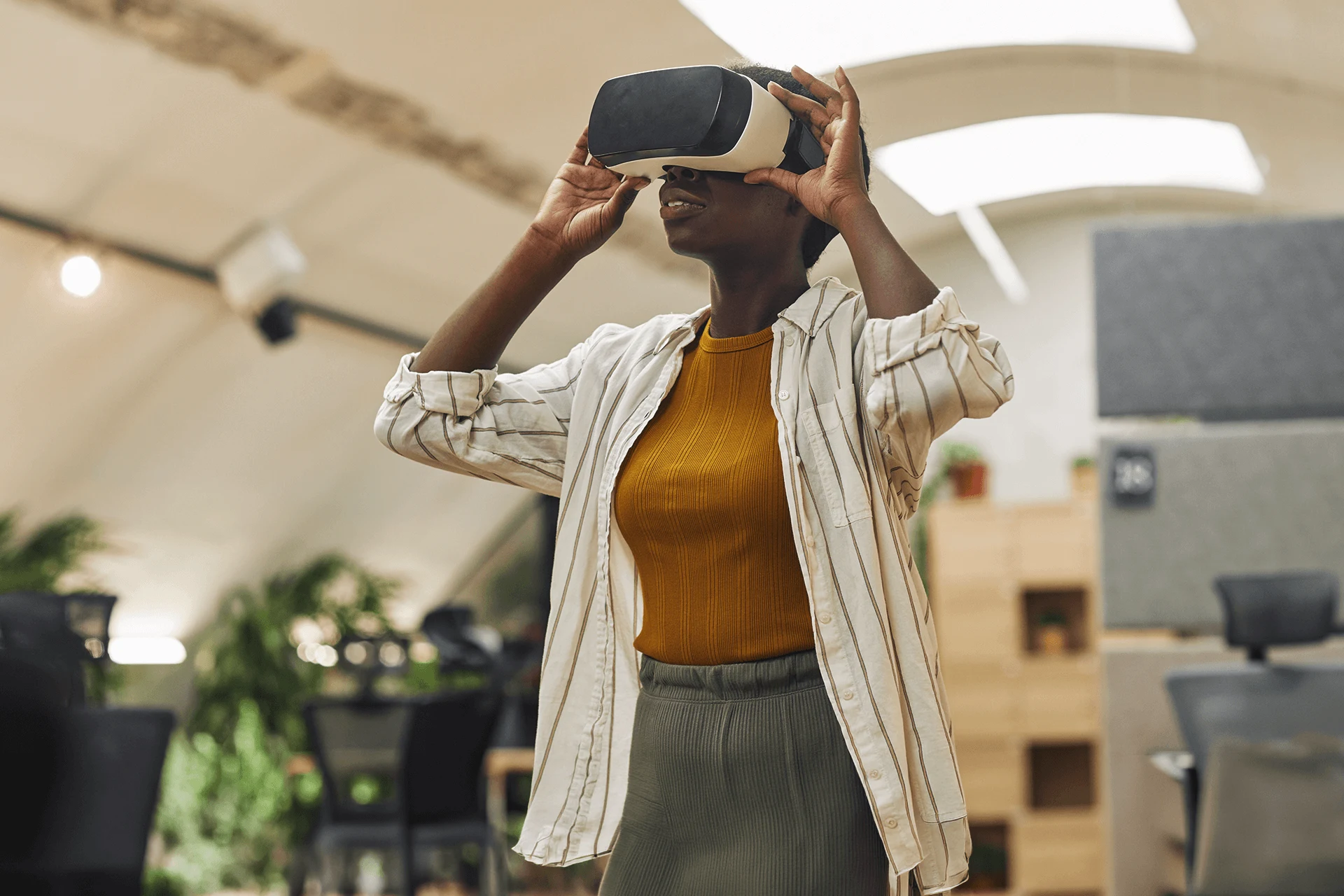 Person wearing VR headset in a modern office environment