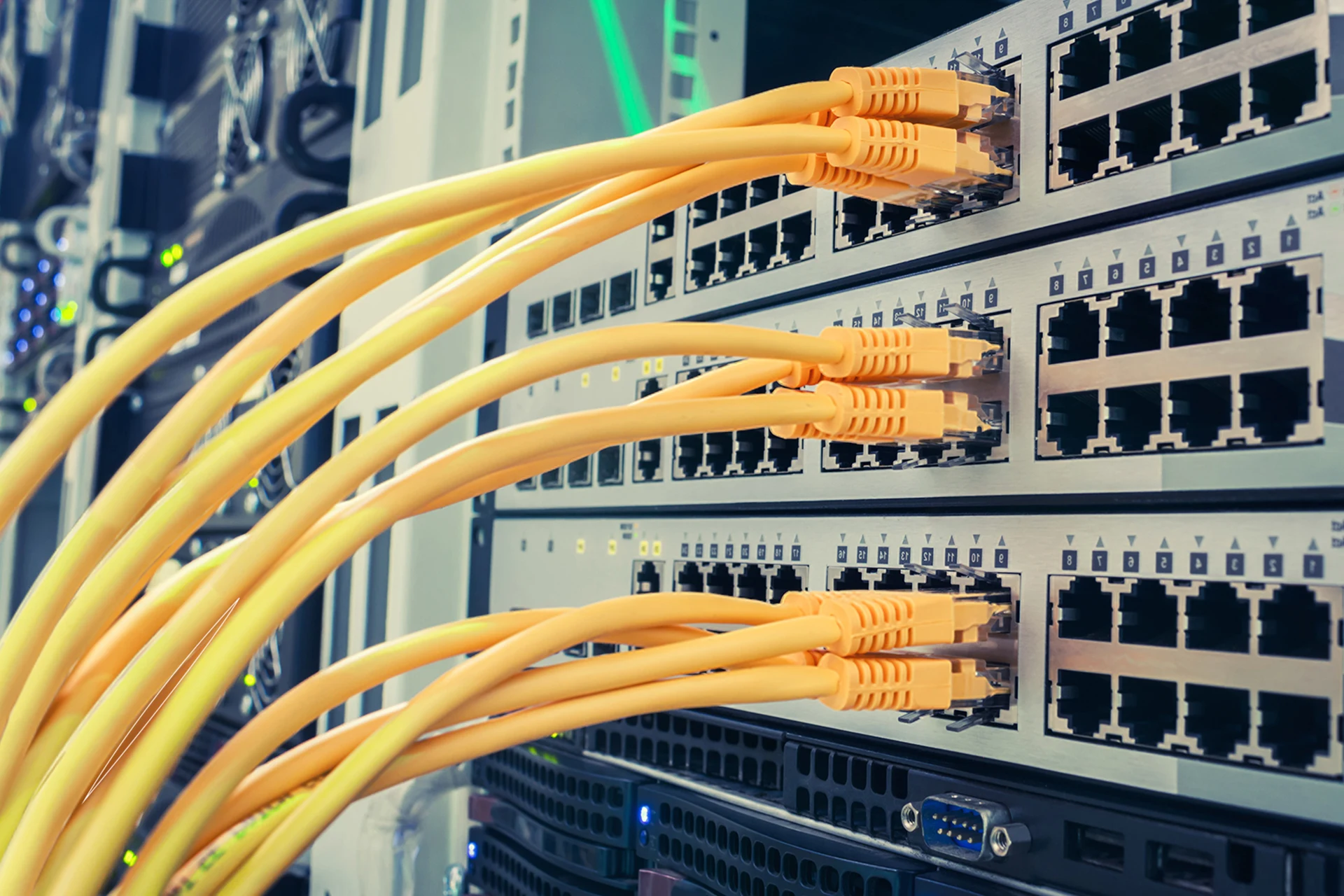 Network switches with yellow Ethernet cables connected in a data center