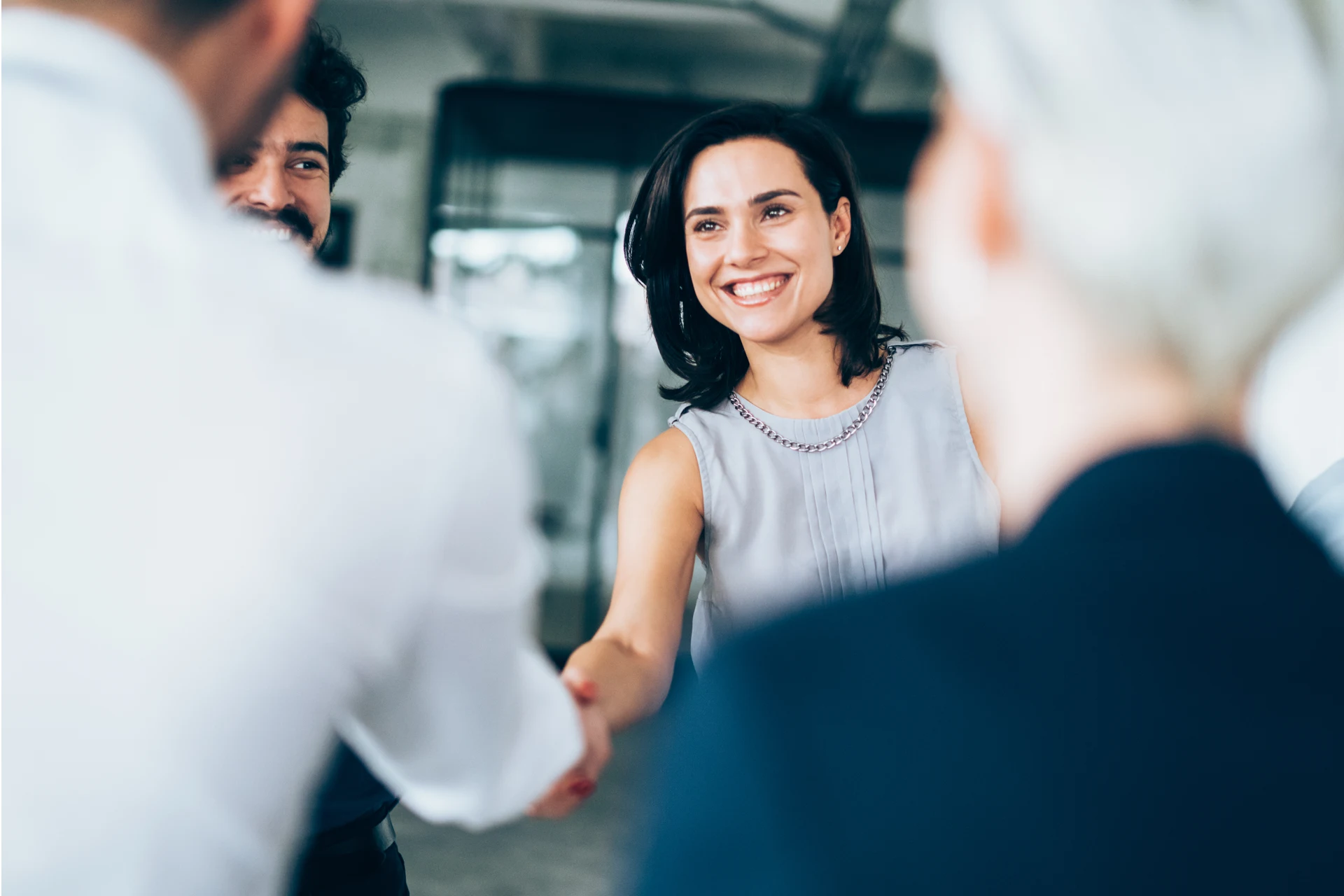 Two professionals shaking hands in a corporate setting
