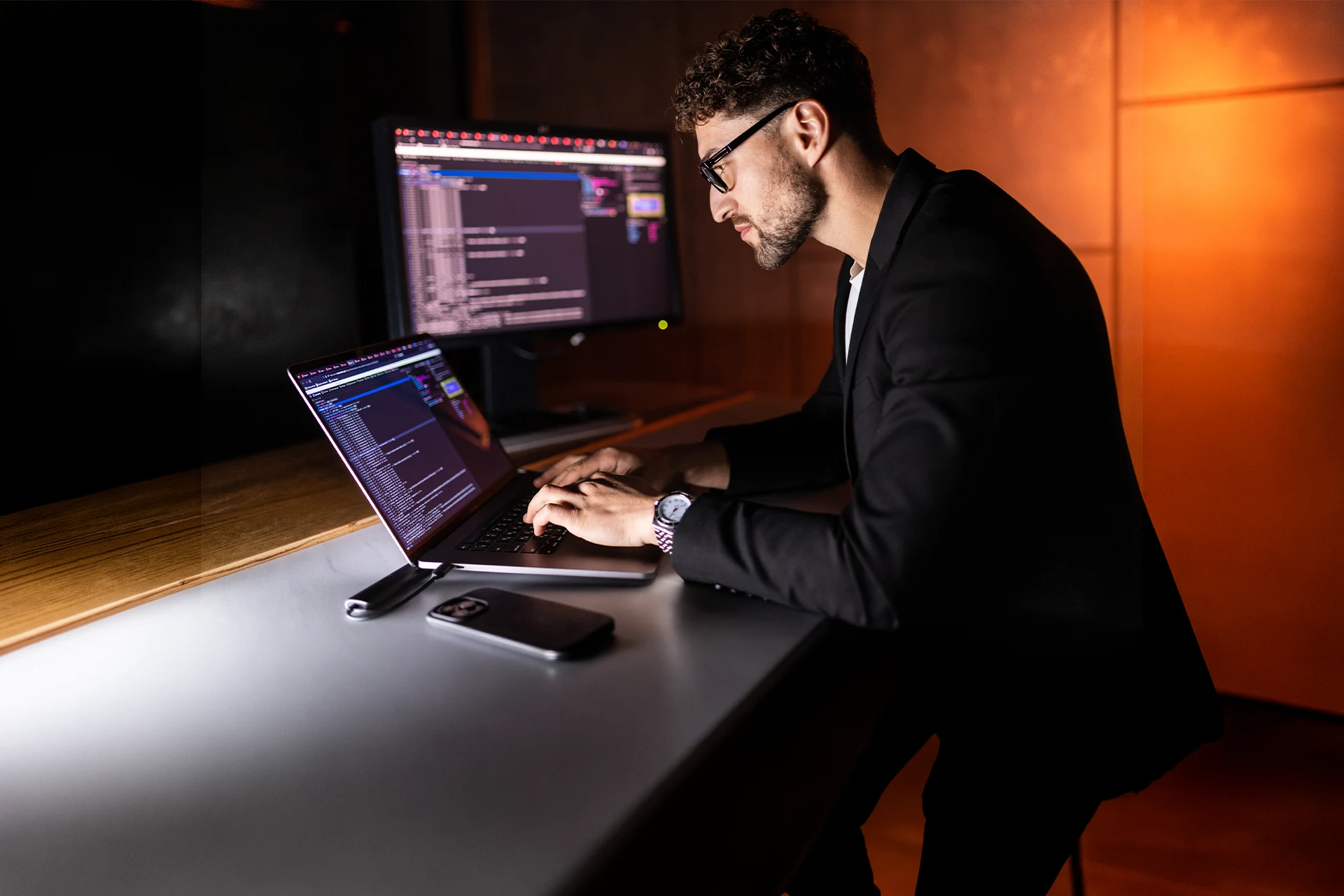 Professional typing on a laptop while working on security applications