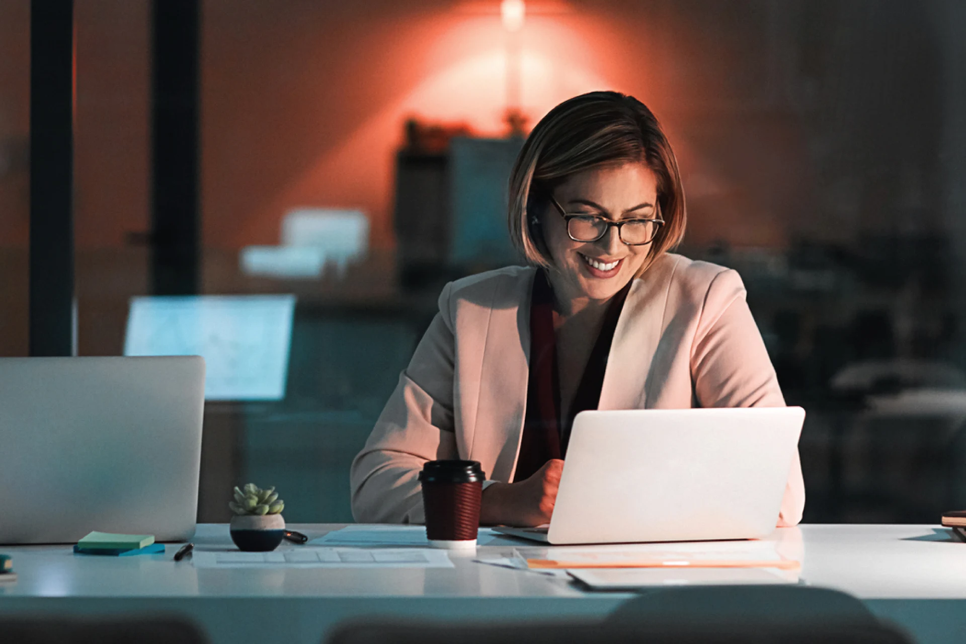 Professional working on a laptop at a desk in an office setting