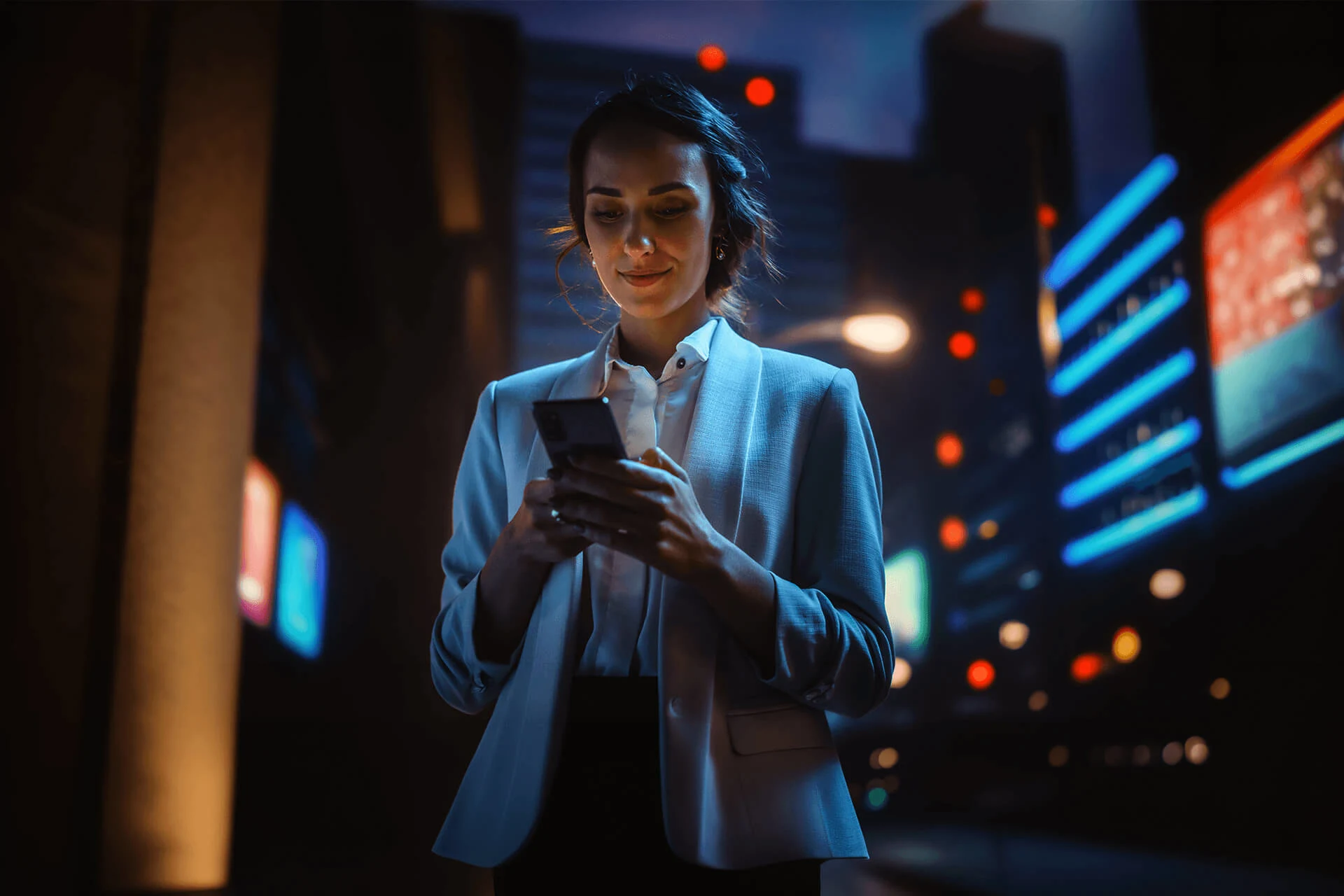 Person using a smartphone in a city at night, highlighting app security.