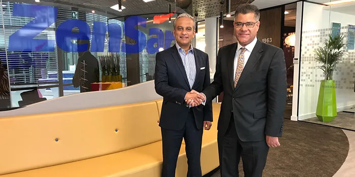 Two men shaking hands inside new Zensar corporate office Green Park UK