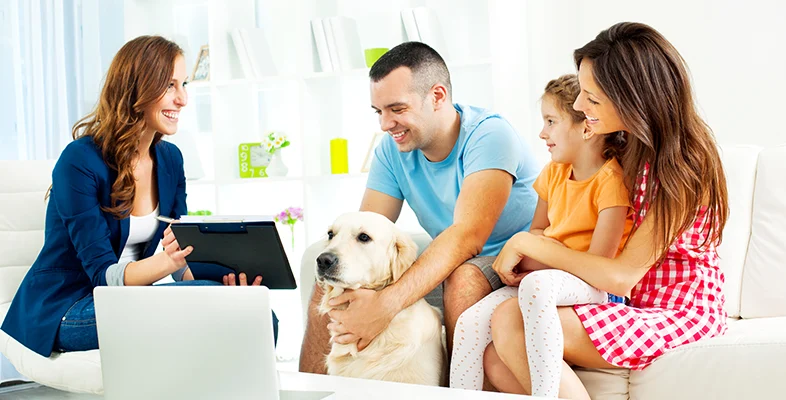 Family consulting with NFU Mutual UK financial advisor in modern living room