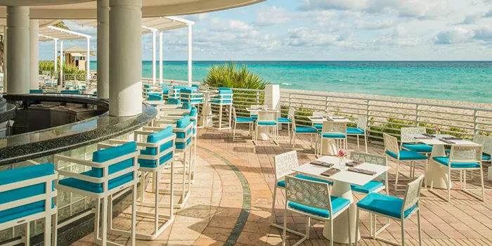 Outdoor beachfront dining setup at Florida venue for Manhattan Associates event