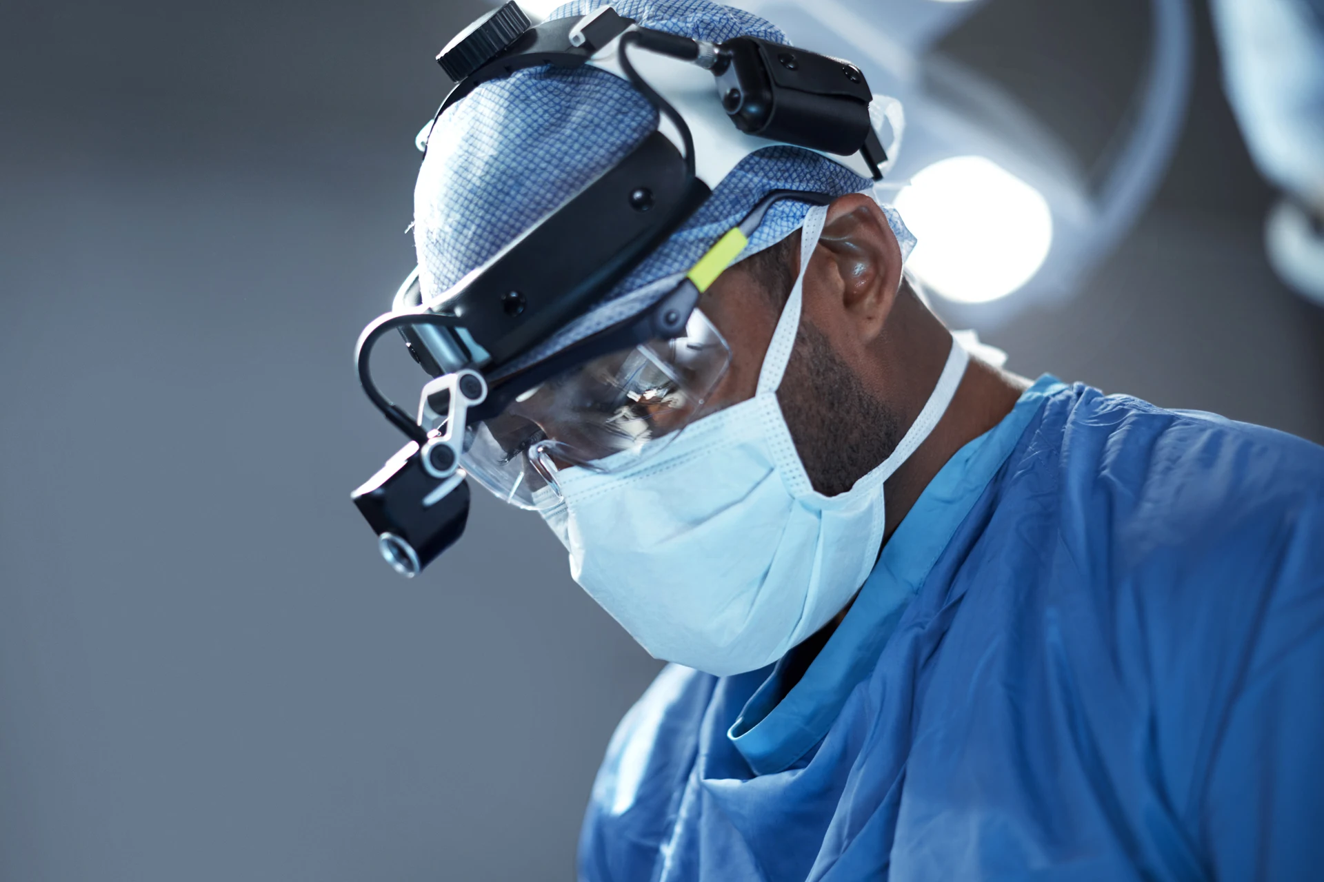 Surgeon focused on a procedure, highlighting healthcare technology usage