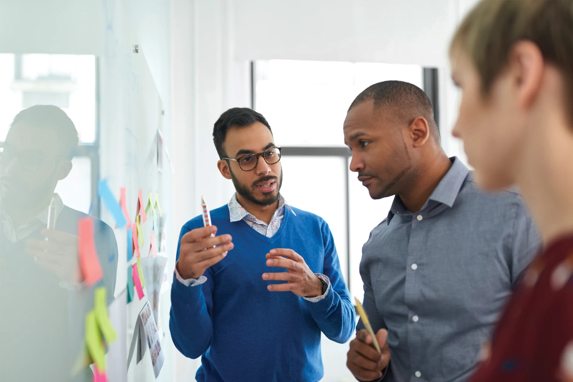 Team members discussing technology solutions for business transformation