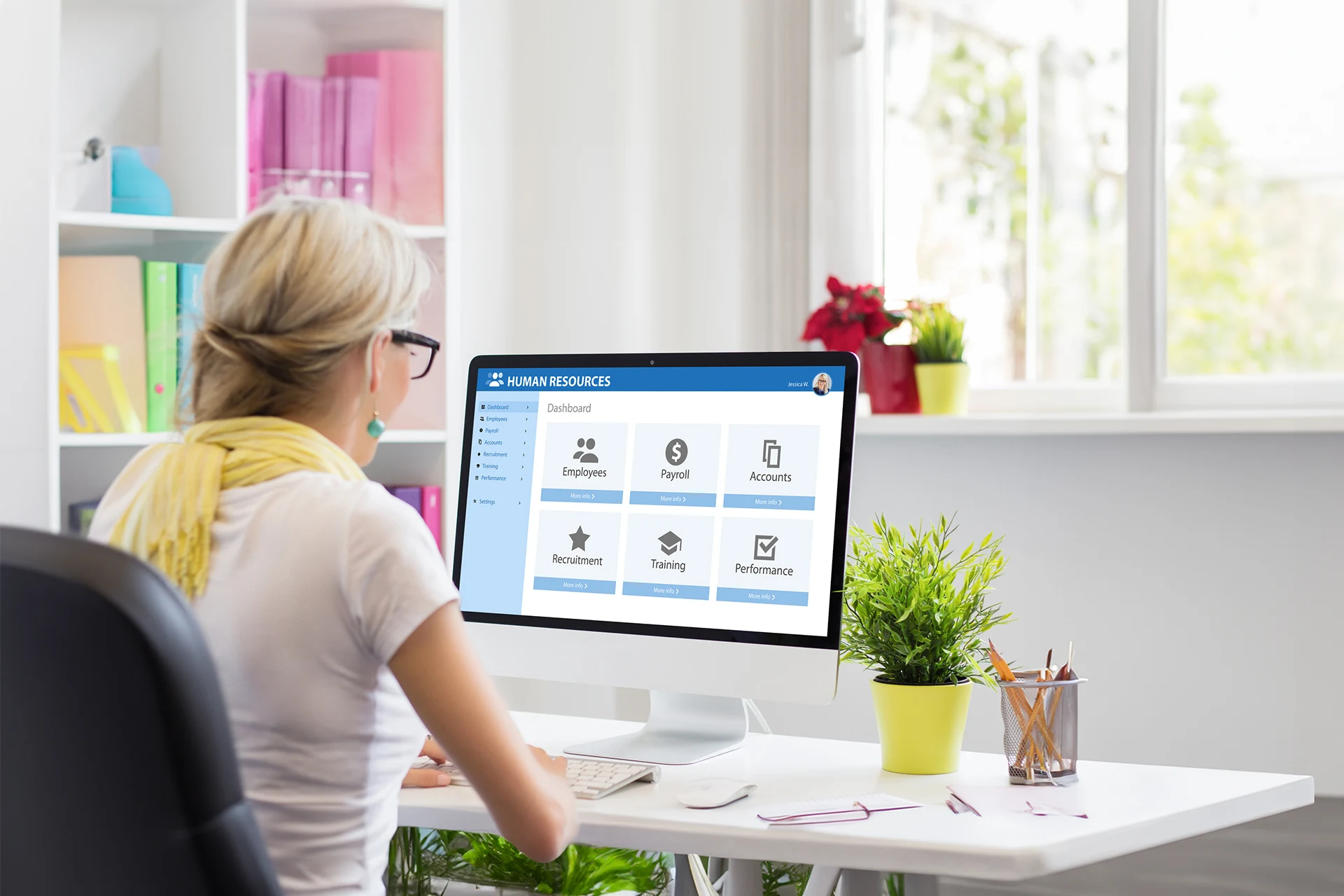 User interacting with a human resources dashboard on a computer.