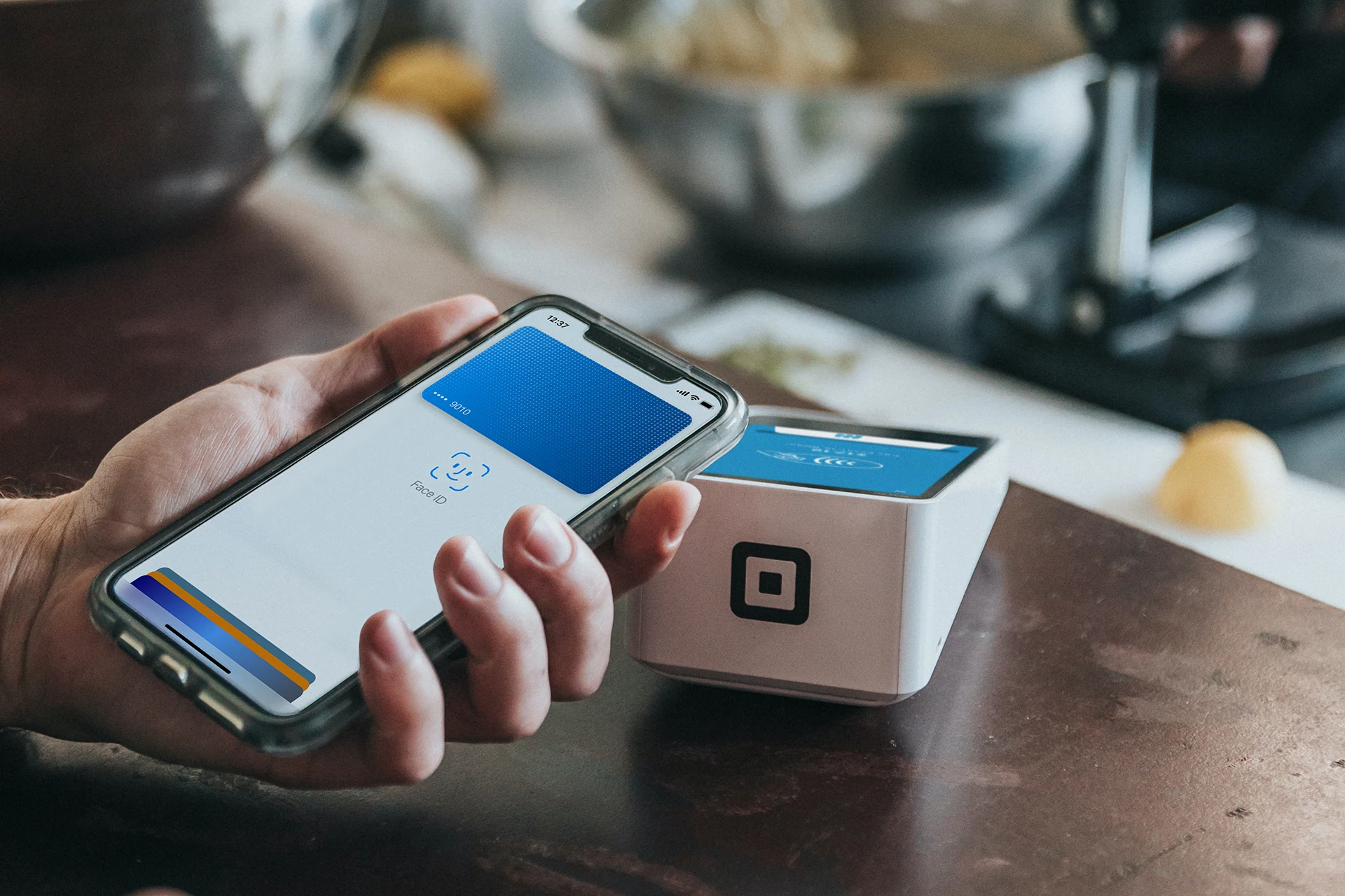 Person using a mobile phone for a contactless payment transaction