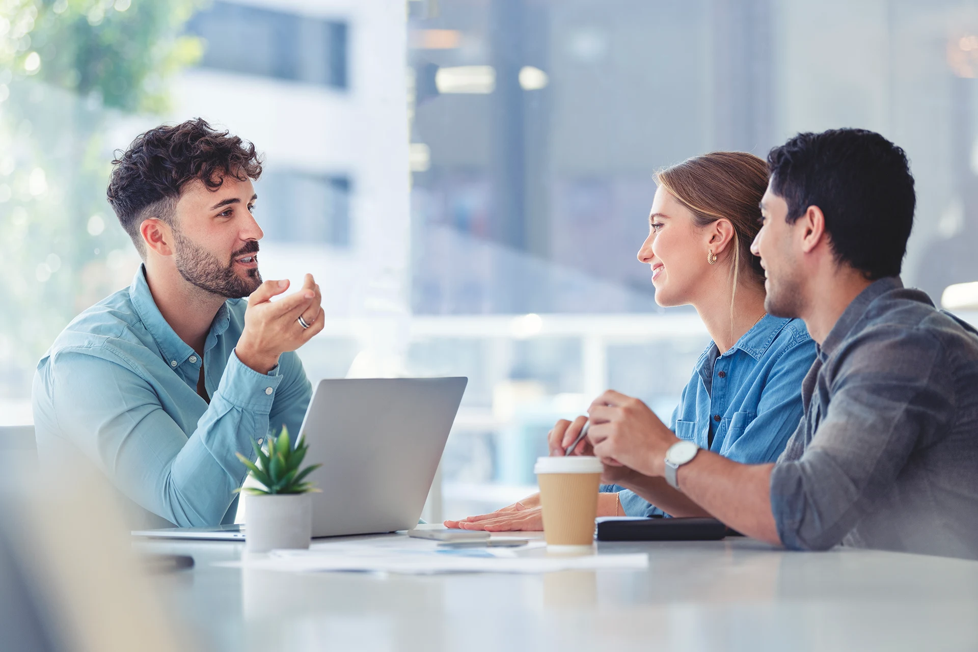 Three professionals discussing enterprise content management strategies