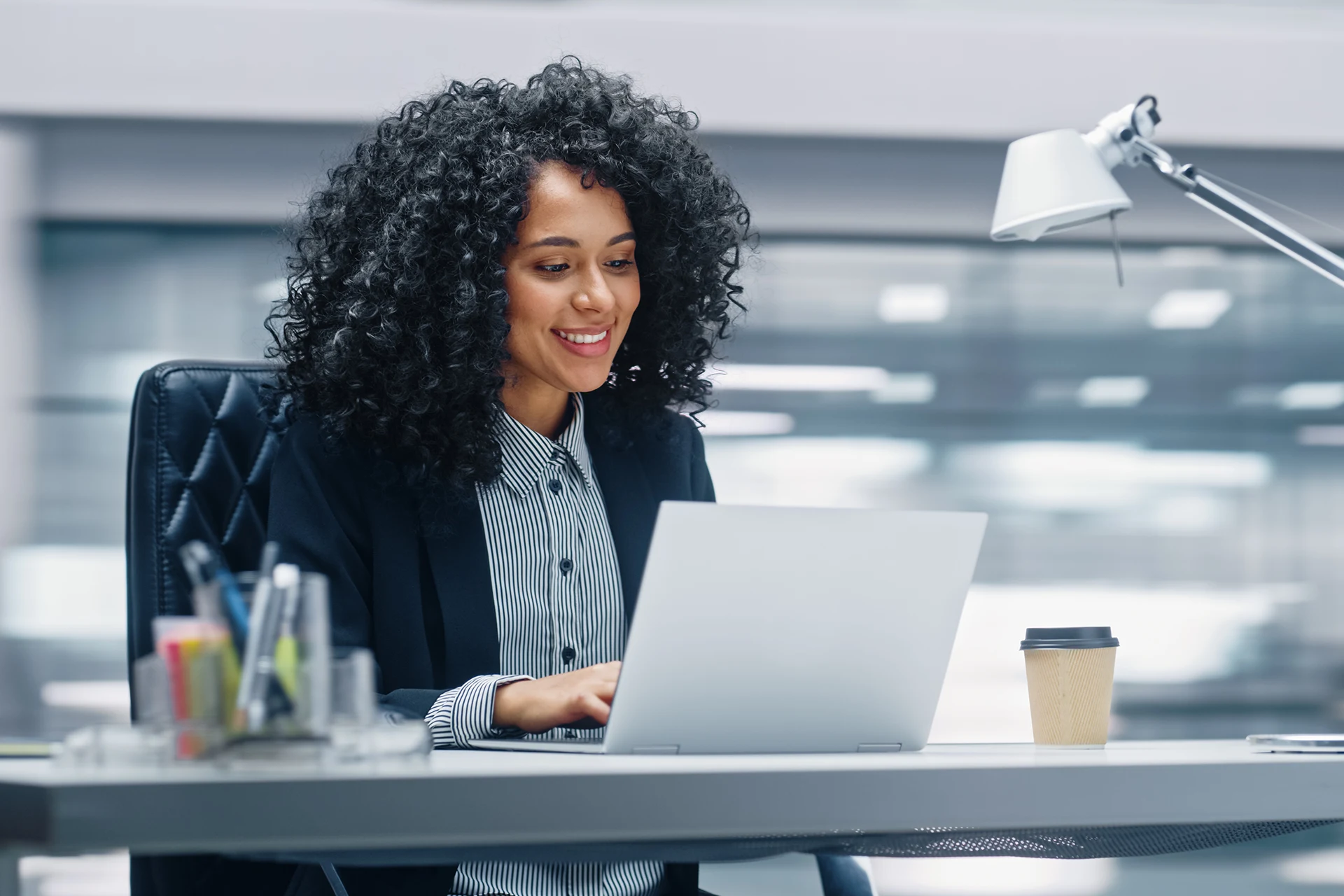 Professional working on a laptop in an office environment