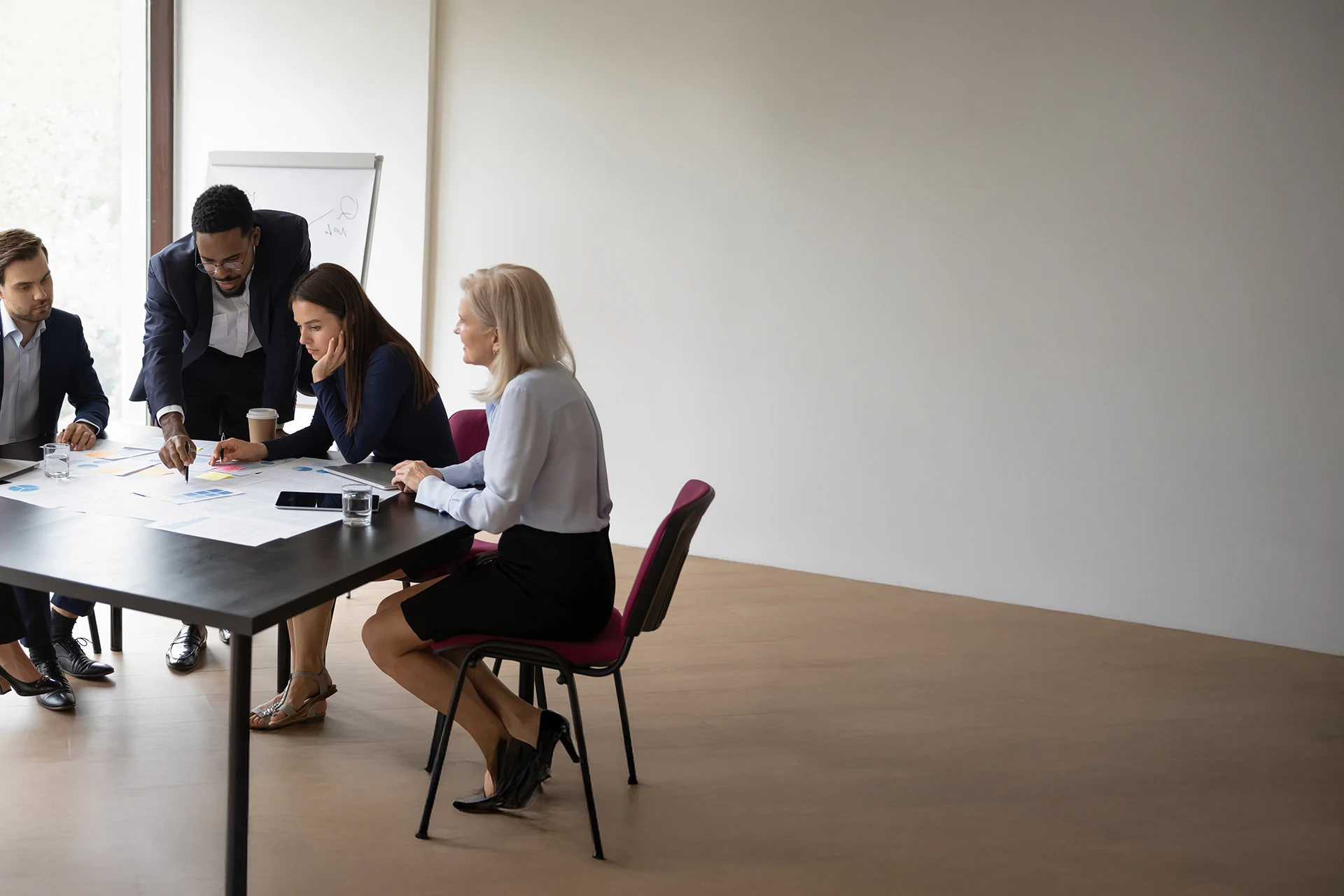 Group of professionals collaborating around a table in a meeting room