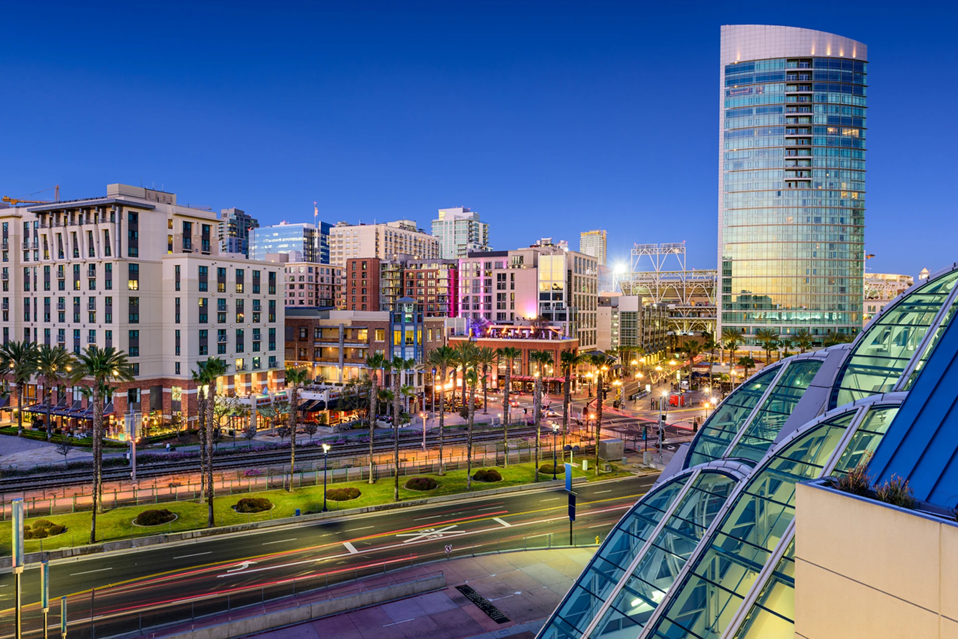 Skyline cityscape of downtown San Diego California palm trees at dusk