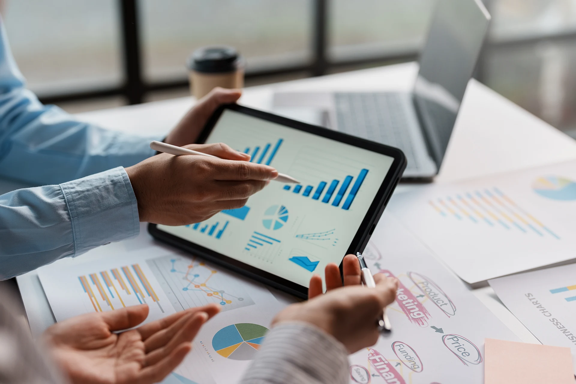 Hands discussing data on a tablet in a commercial lending setting
