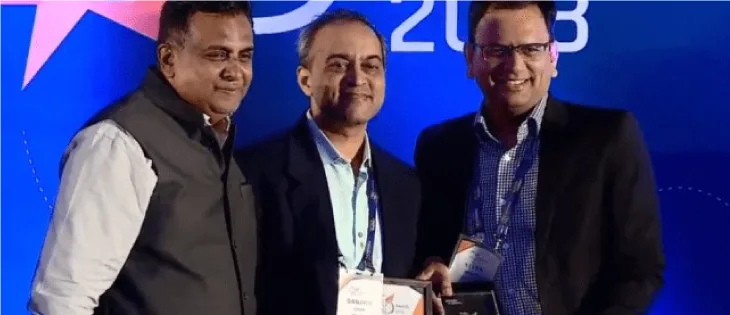 Three professionals receiving People Matters L and D Future Tech Award on stage