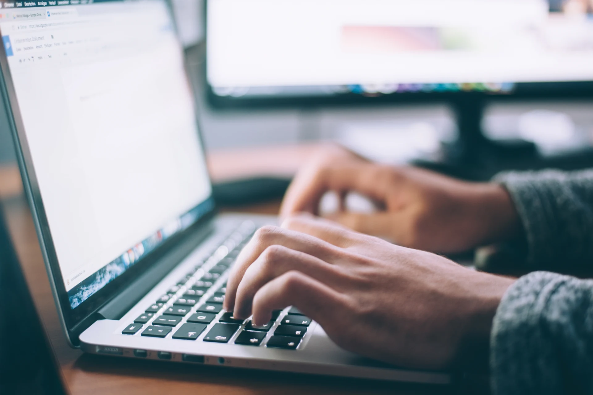 Hands typing on a laptop, emphasizing digital security initiatives.