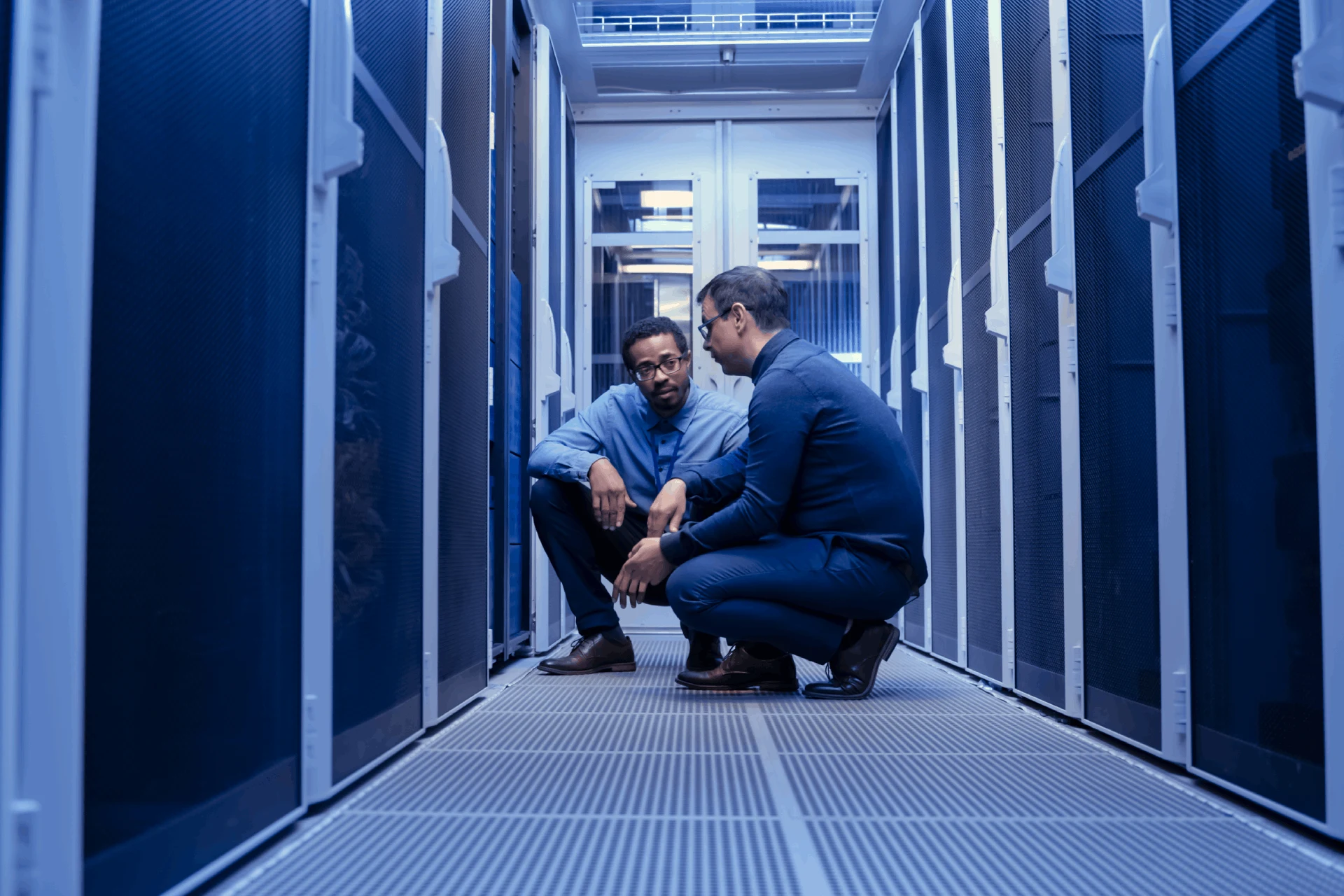Two professionals discussing infrastructure in a data center