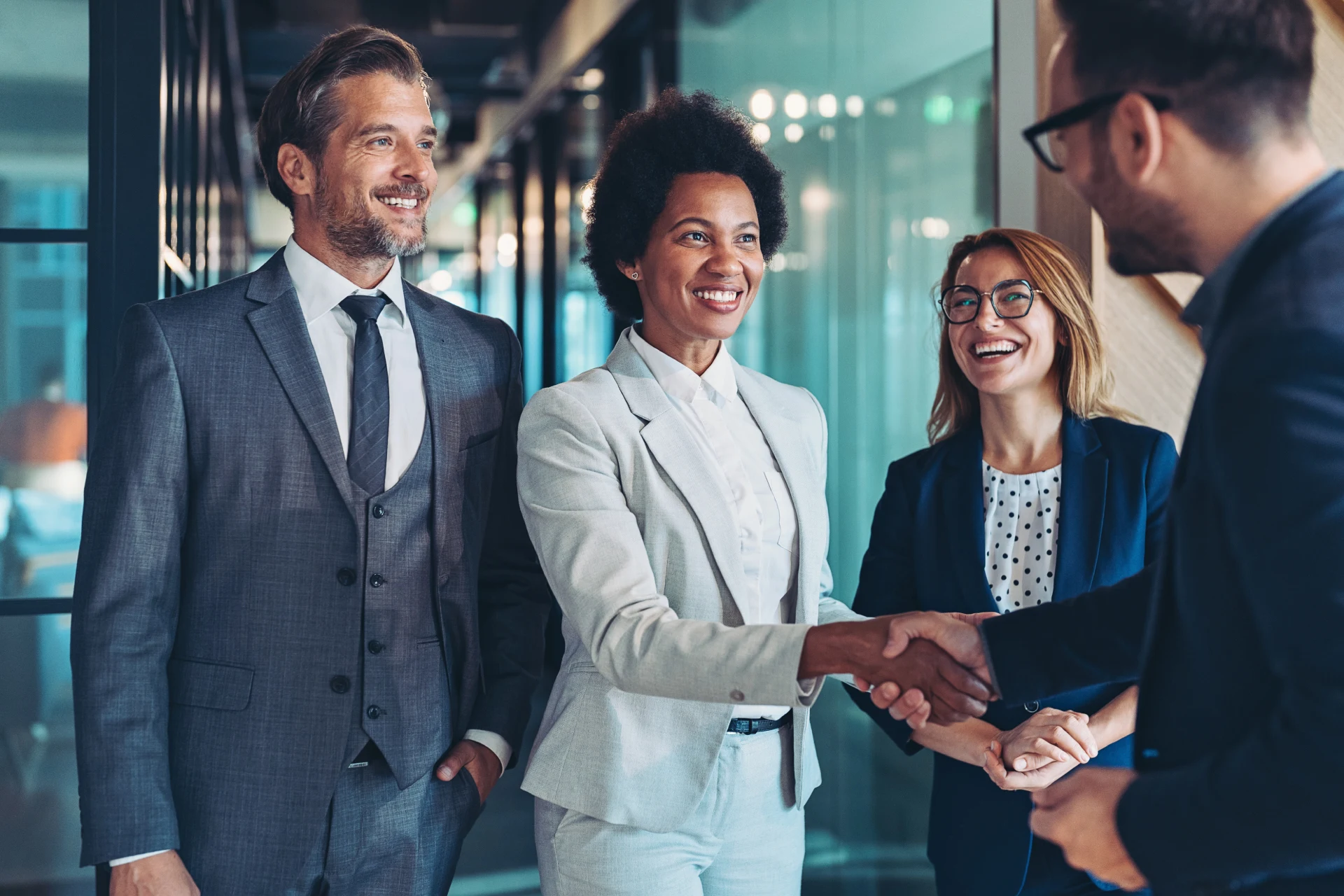 Business professionals shaking hands in a modern office setting