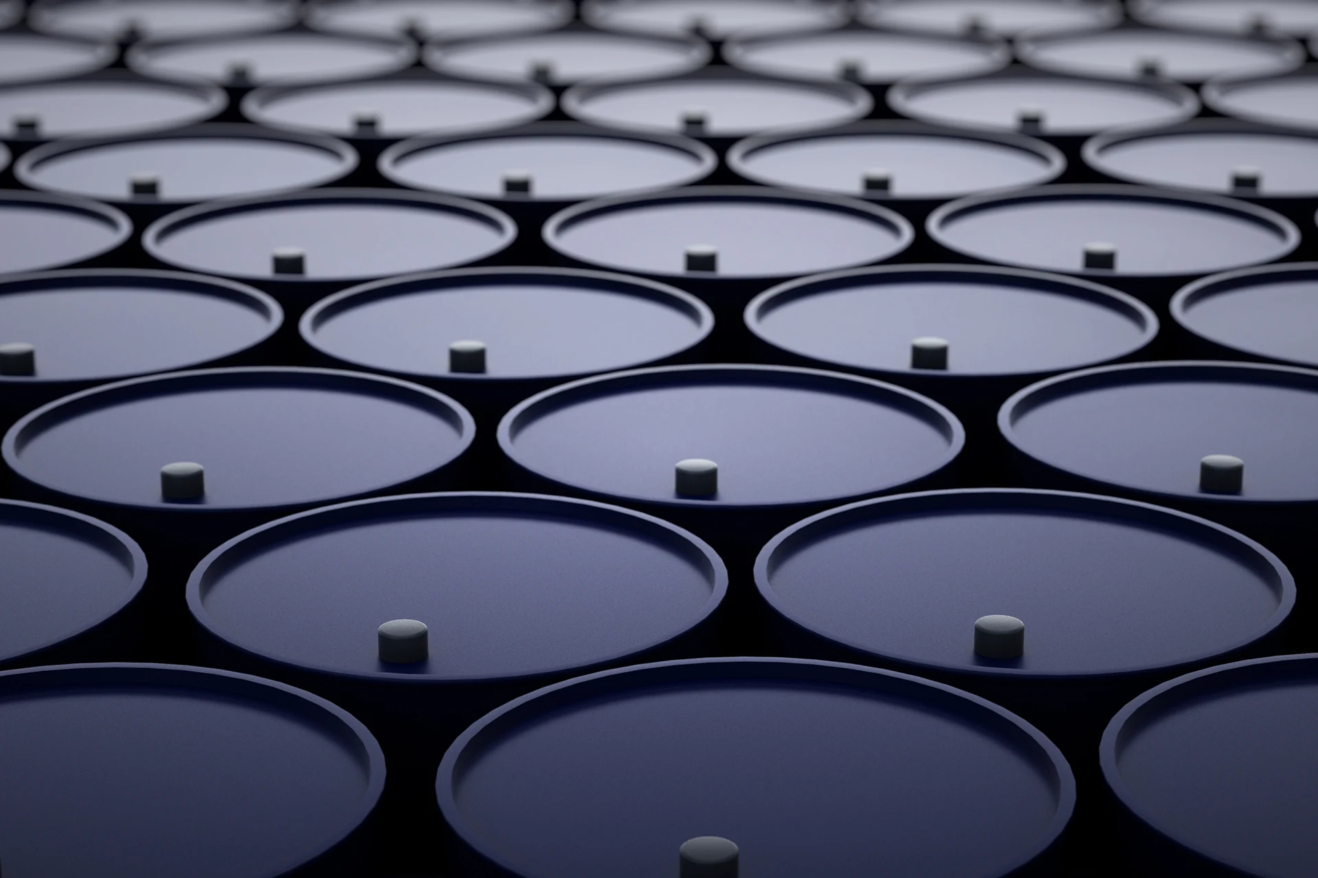 Cylindrical containers arranged closely, representing oil and gas storage.