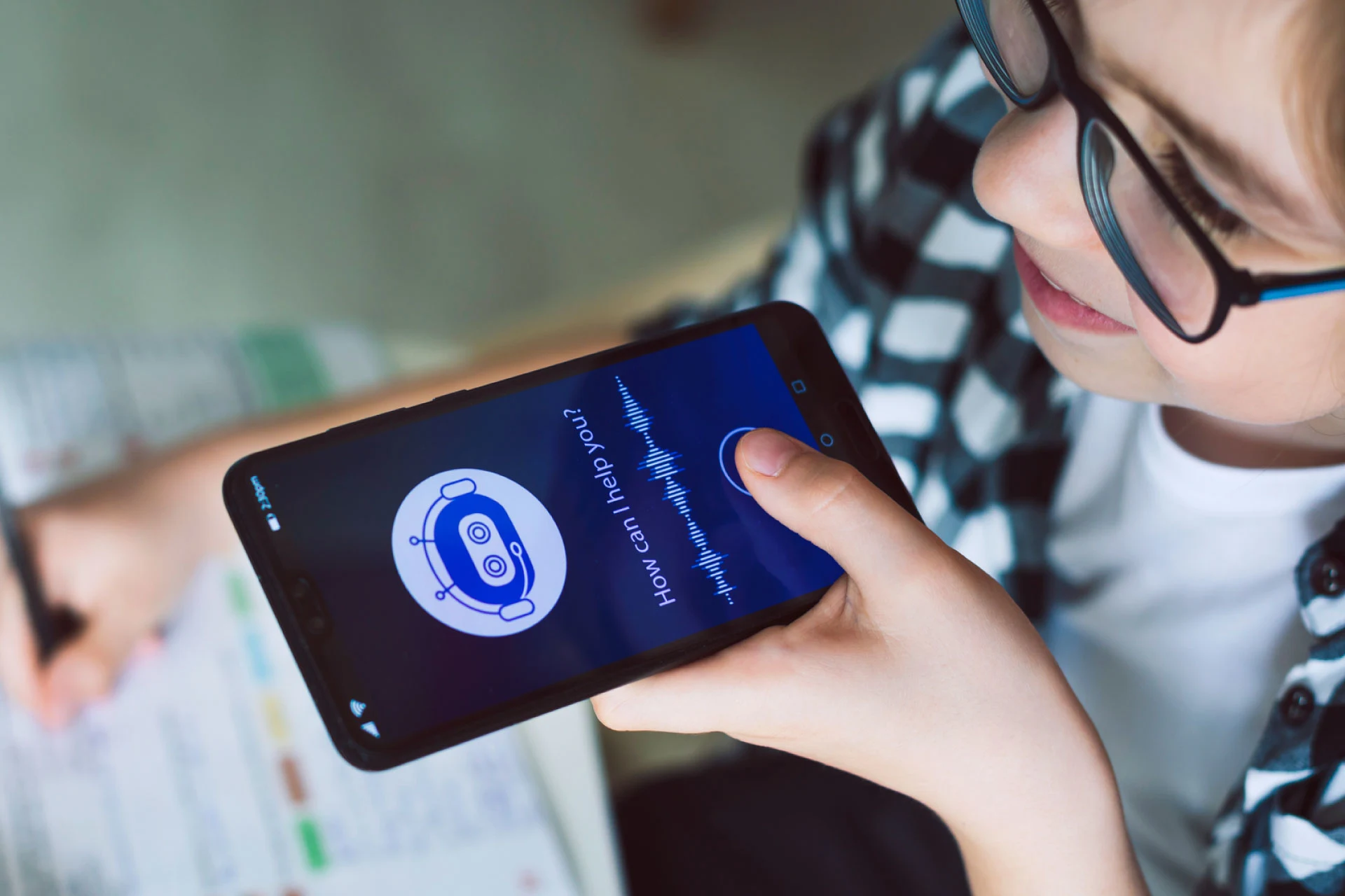 Child using a smartphone with a chatbot interface asking for assistance