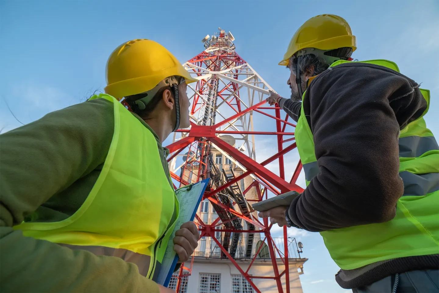 Technicians inspecting a telecom tower during a network upgrade project.