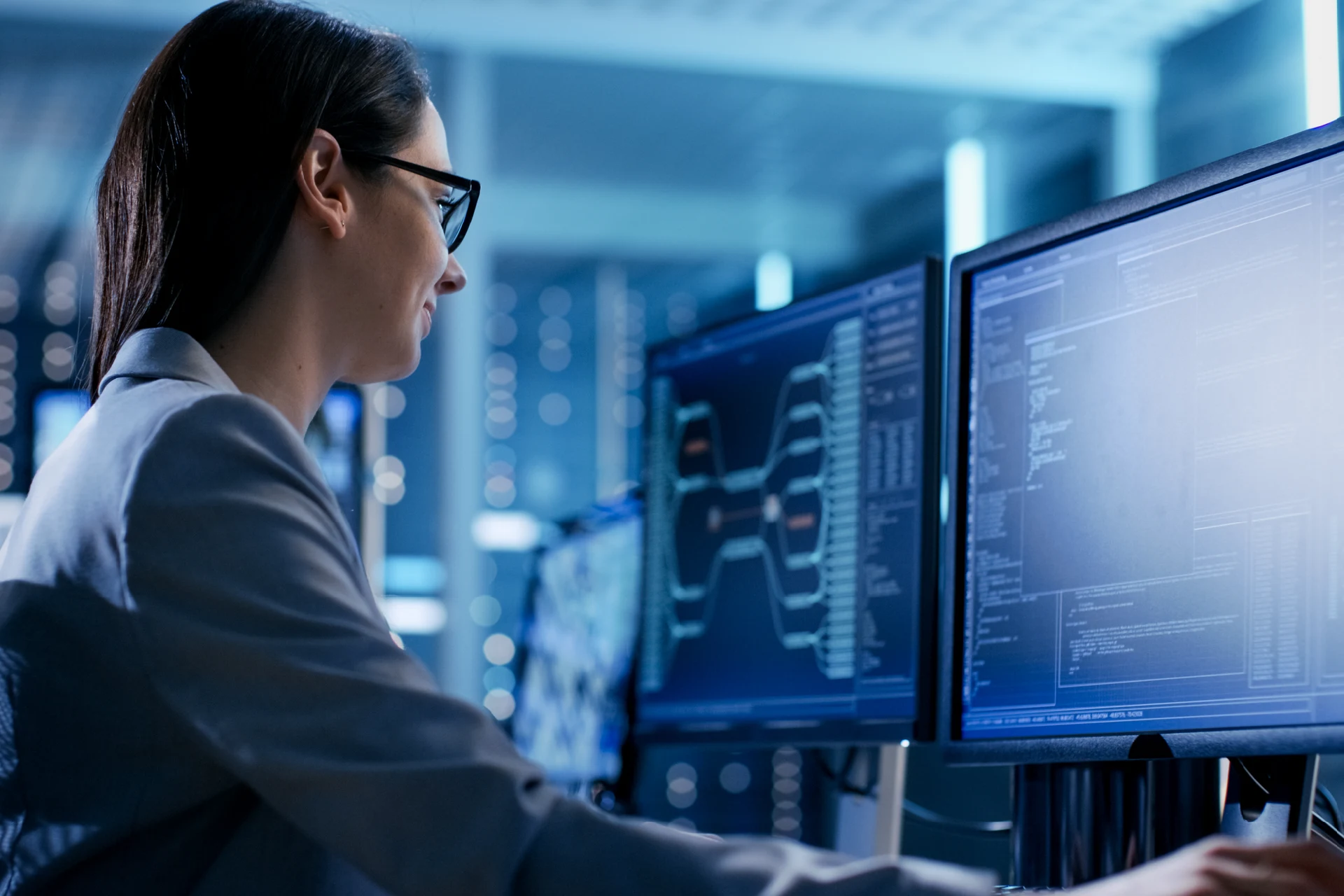 Professional analyzing data on multiple monitors in a cybersecurity setting