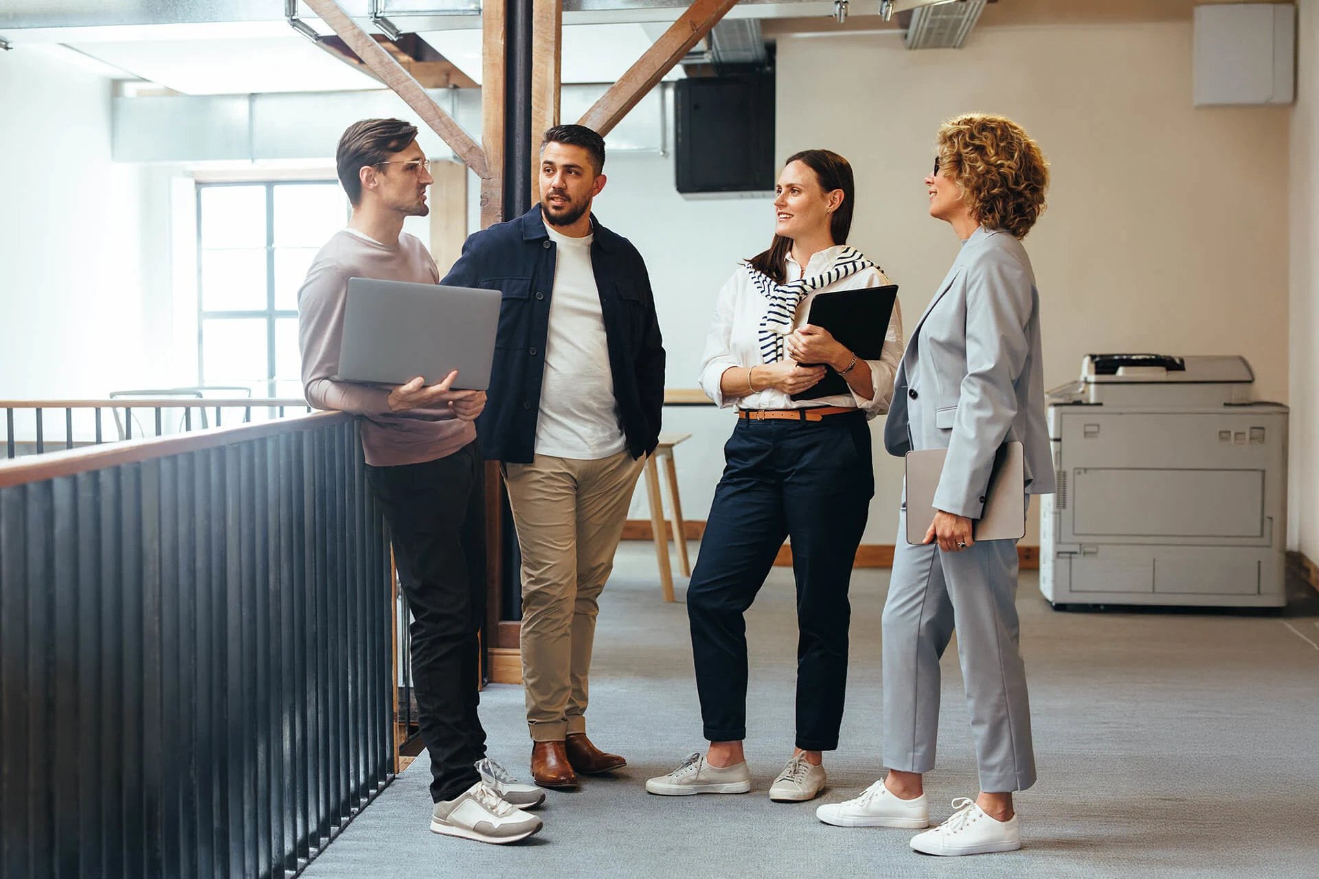 Four professionals discussing digital transformation in an office setting