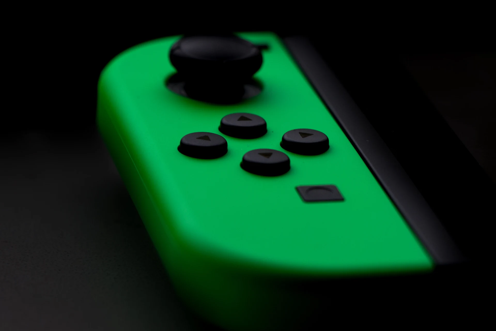 Green gaming controller with buttons, representing quality in gaming.