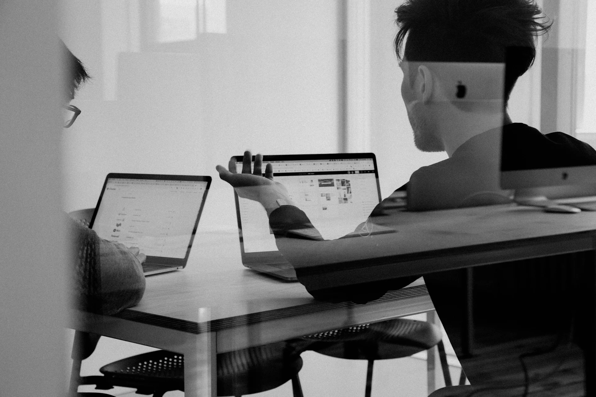 Two professionals discussing digital transformation strategies in a meeting room