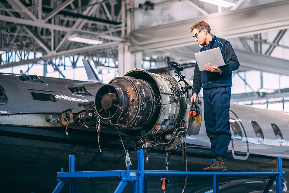 Engineers working on aircraft components with digital manufacturing technology