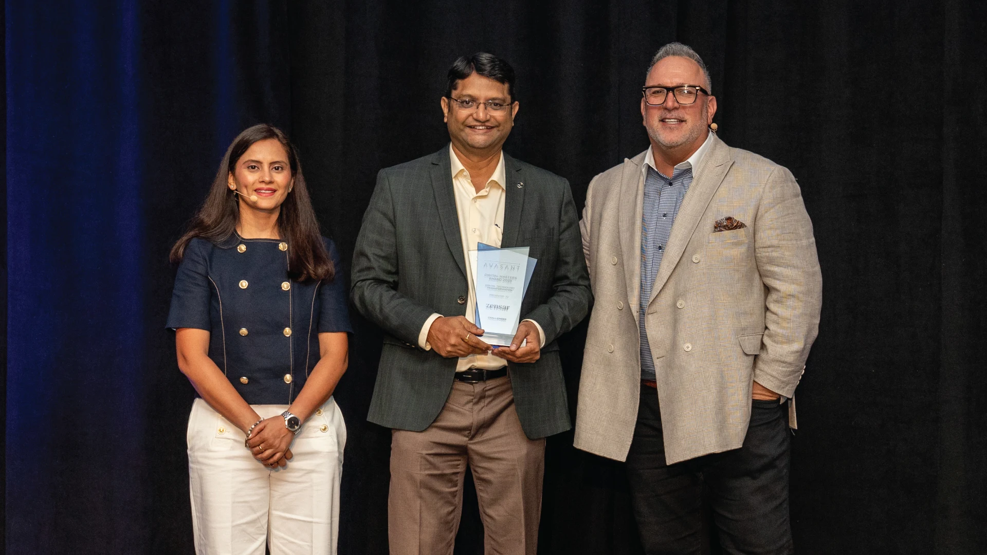 Three professionals holding plaque for Avasant Digital Masters Awards 2025