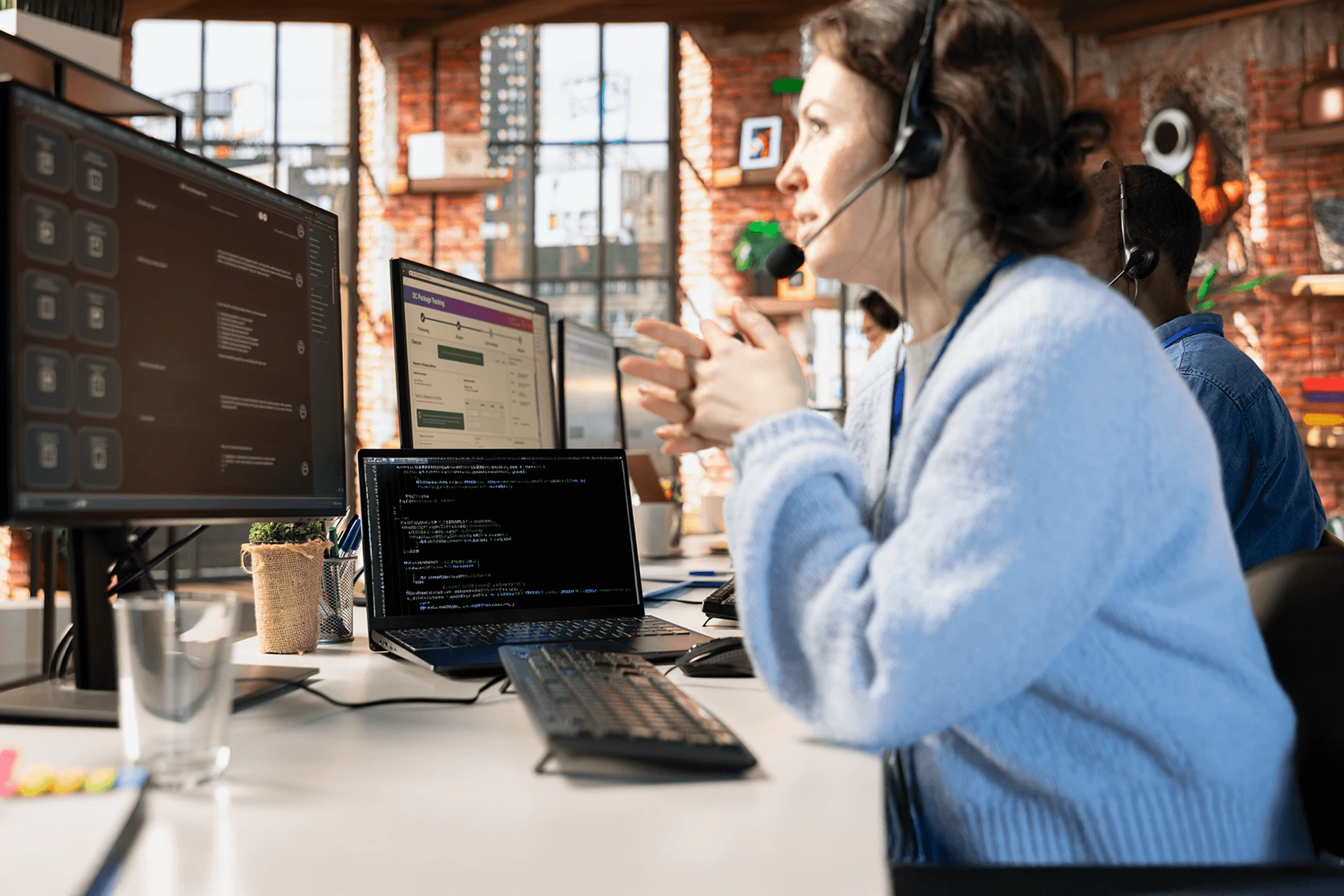 Professional discussing call center operations while using computers