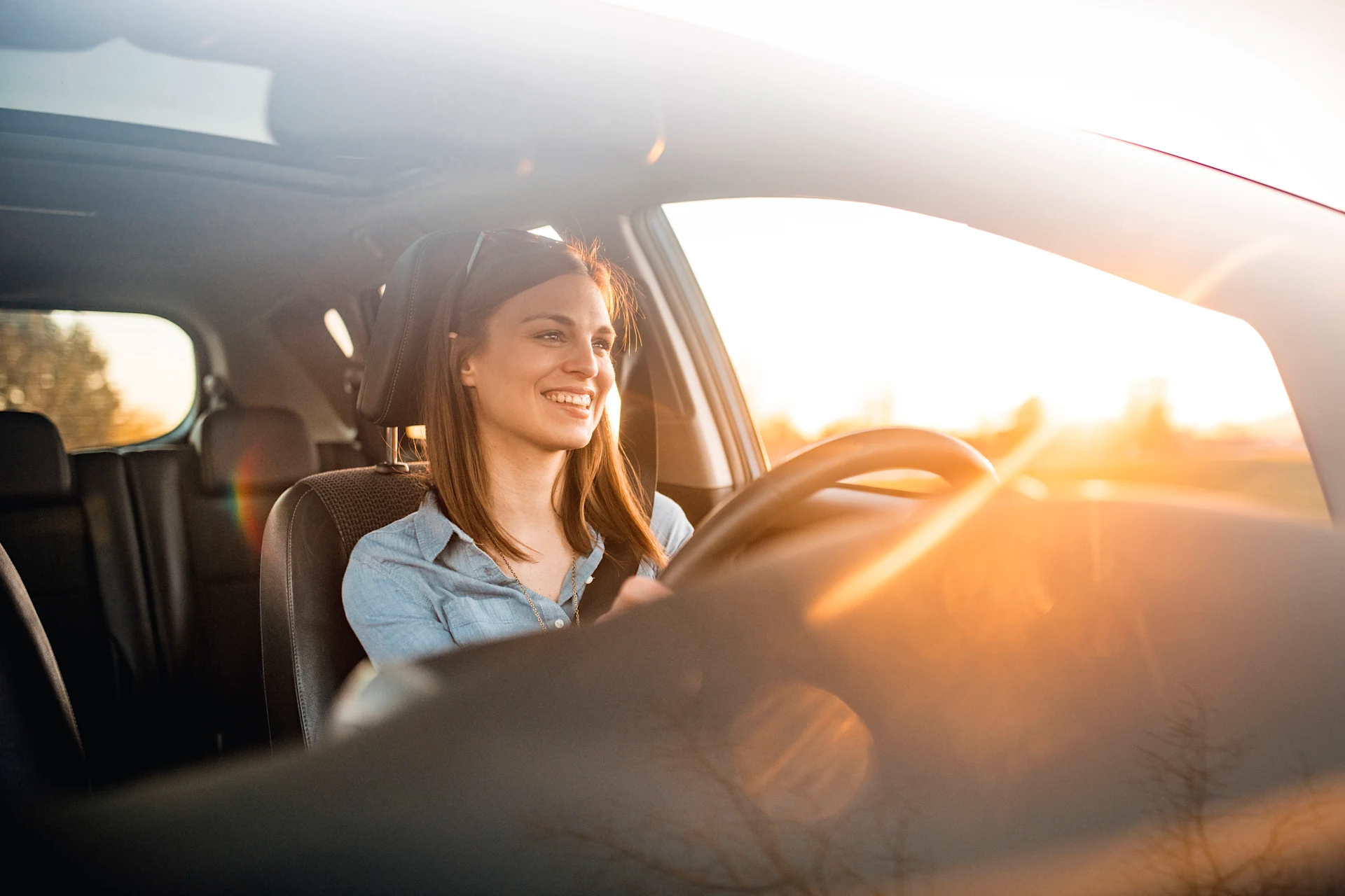Person driving in a car, related to automobile insurance technology.