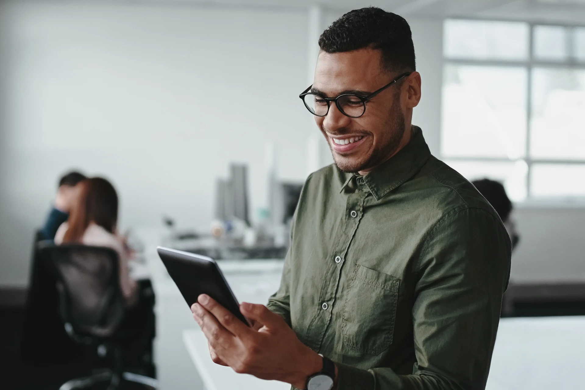 Professional using a tablet in a modern office setting