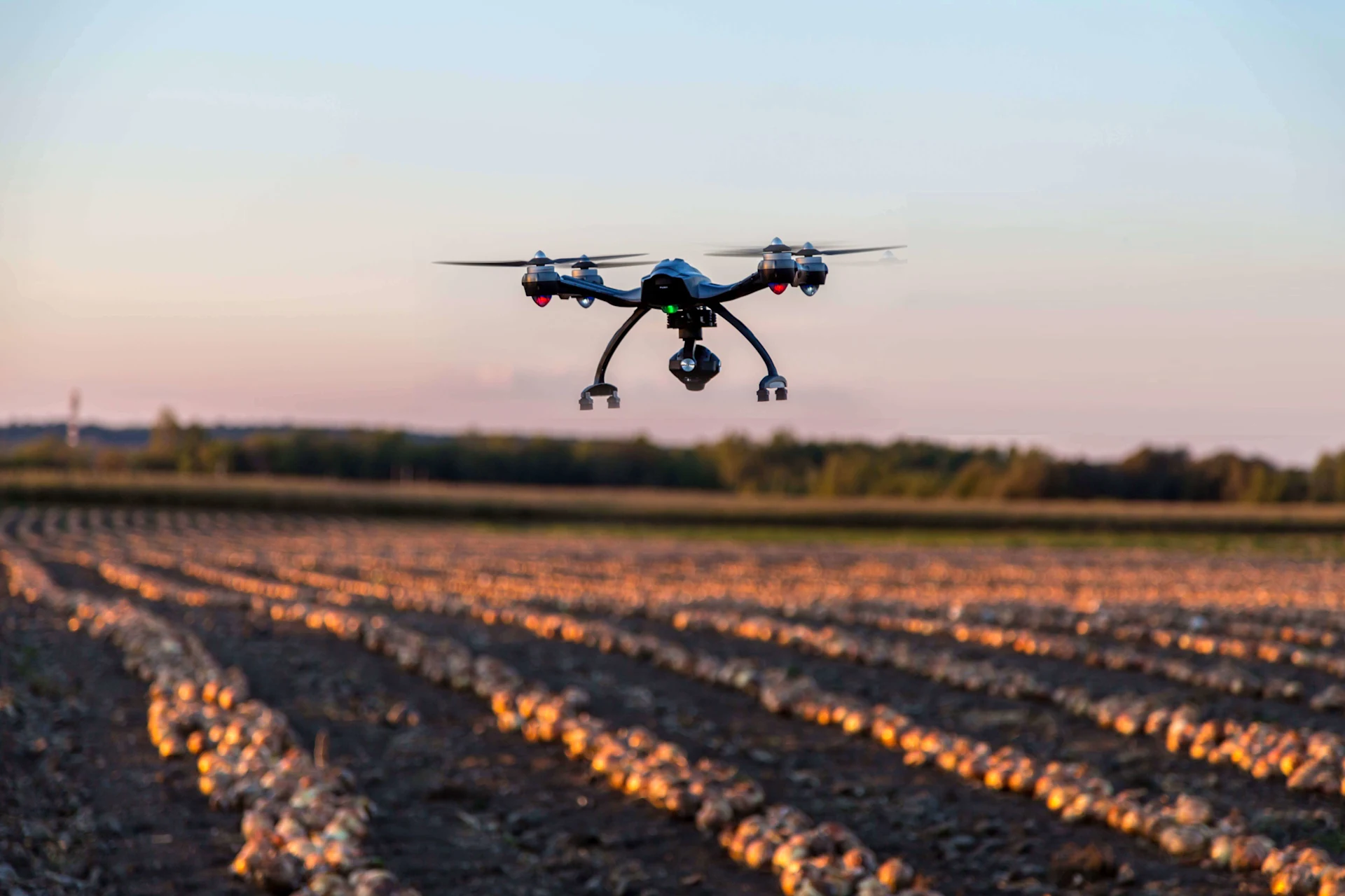 Camera drone flying over agricultural green farmland for PTC ThingWorx IoT