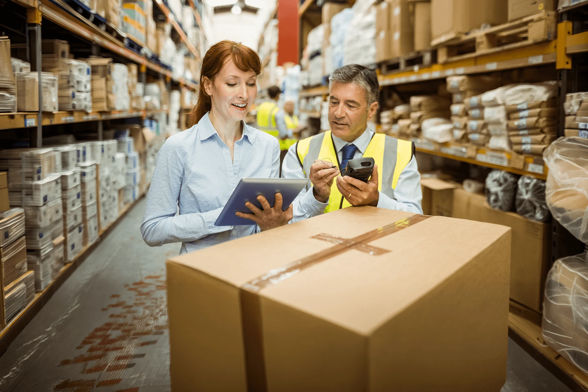 Employees discussing shipment details in a warehouse environment