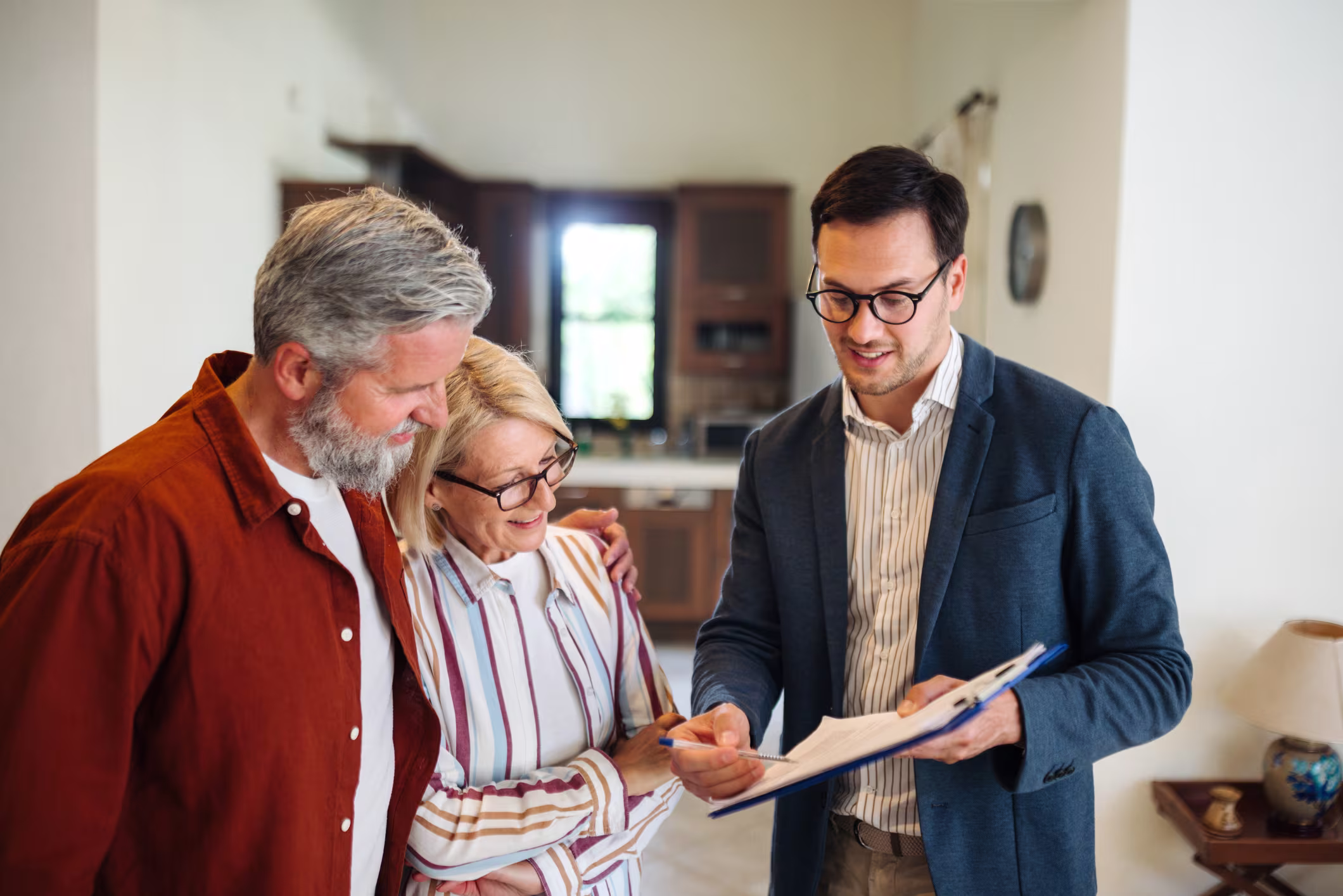 Agent meeting with sellers at a kitchen table