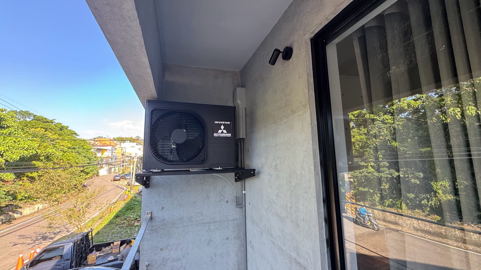 三菱重工空調一對一安裝案例，室外機黑化包膜處理，鐵架同步黑色烤漆融入建築立面