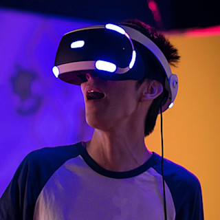 A mesmerized guy playing on his VR headset