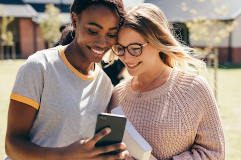two girls looking at phone
