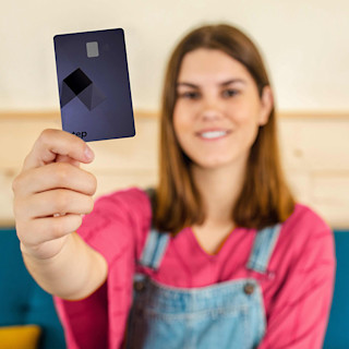 A happy girl holding a Step Card