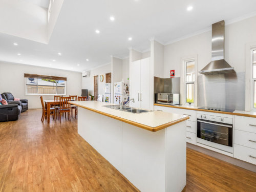 The lovely open-plan kitchen, dining, and living area of this Port Lincoln townhouse. 